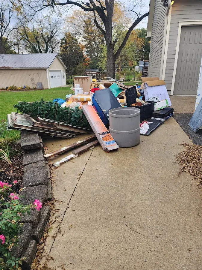 Dumpster being loaded with debris for Residential Dumpster Rental in South Hill
